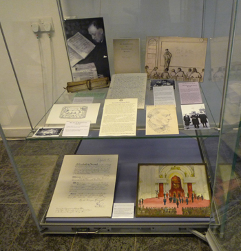 The second showcase focused on Rev J S Purvis, our first Director. At the bottom: his OBE certificate and his sketch of the scene at Buckingham Palace when he received his OBE in 1958